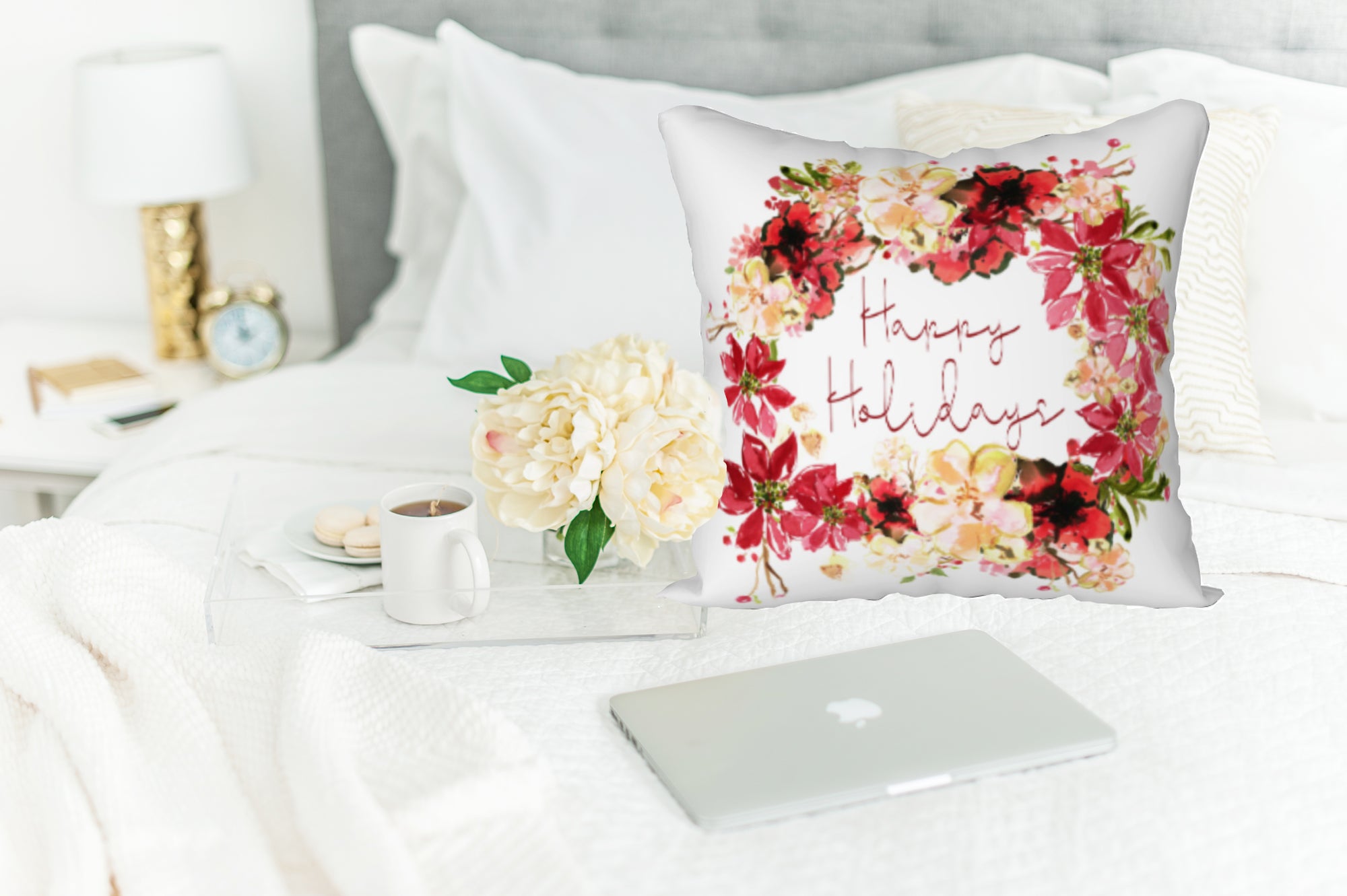 Pretty poinsettias and beige flowers surround the words "Happy Holidays" on this square pillow.  The image is printed on a white background. Perfect for a bedroom, a living room, a soft plush chair or anywhere you might want a pop of holiday cheer!