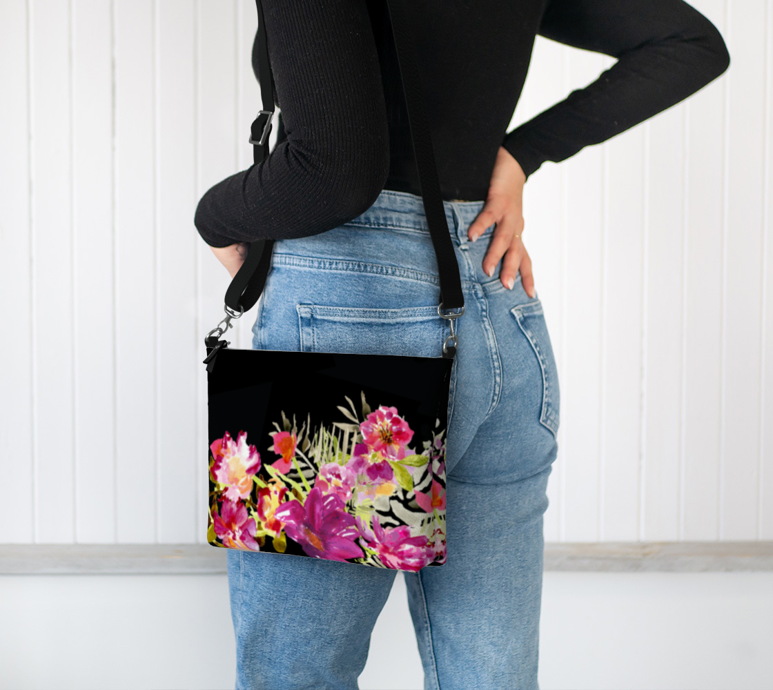 Black floral crossbody. Beautiful pink and coral flowers  with a crossbody straw.