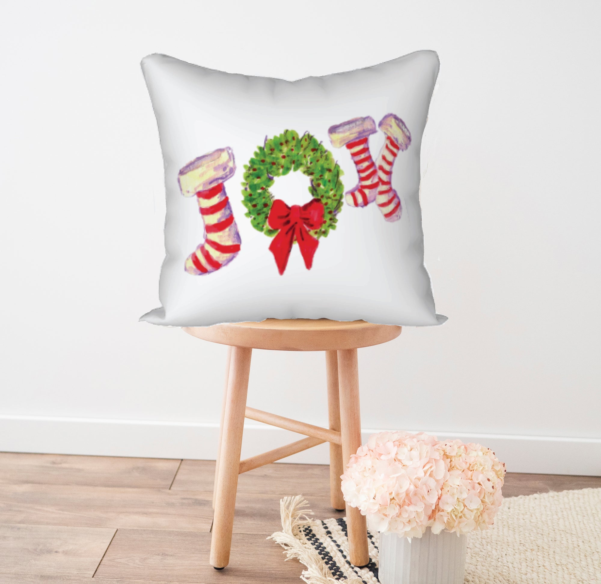 Joy to the World with this festive Joy Pillow. Watercolor image printed onto this square pillow. Will add a pop of festivity to any Christmas Holiday. There is a wreath painted in the middle of the two stocking letters to create the word JOY. White background with red and white striped stockings.